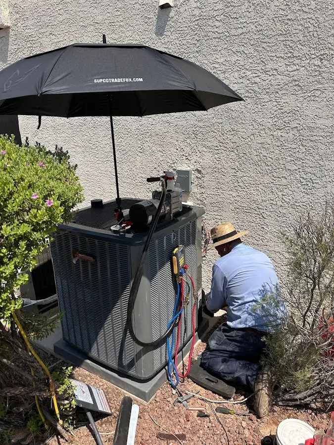HVAC technician performing outdoor AC maintenance in Bel Air North