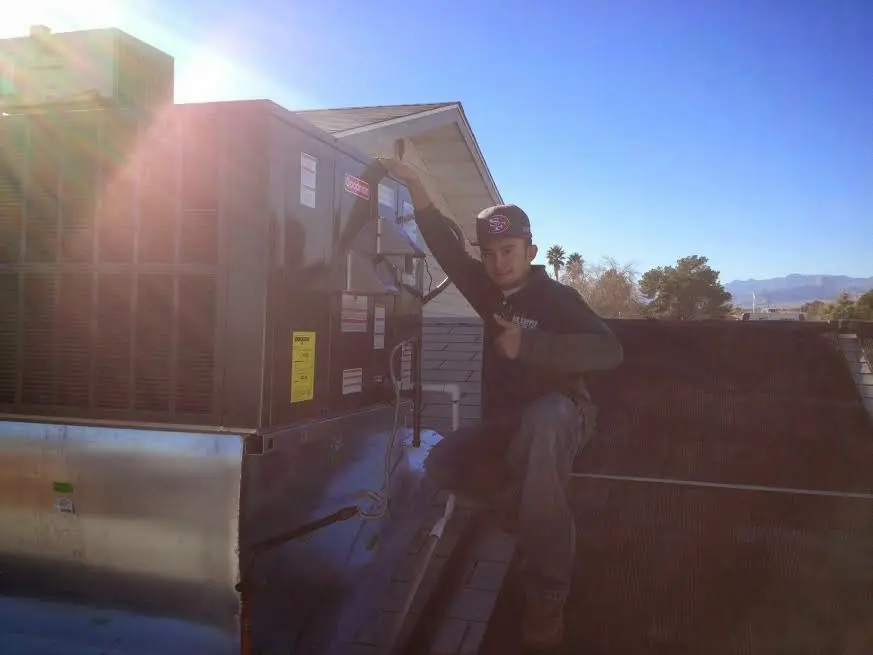HVAC technician performing HVAC Inspection on a rooftop unit in Bel Air North
